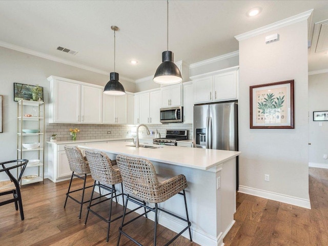 332 Adams St, Georgetown, TX 78628 - kitchen with stainless steel appliances, a sink, white cabinetry, light countertops, and crown molding