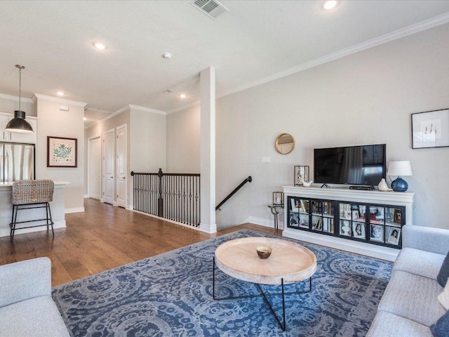 332 Adams St, Georgetown, TX 78628 - living room featuring wood finished floors, ornamental molding, recessed lighting, and baseboards