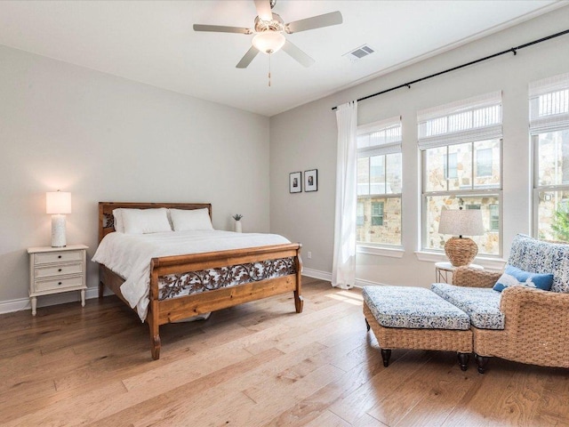 332 Adams St, Georgetown, TX 78628 - bedroom with light wood-type flooring, baseboards, and a ceiling fan