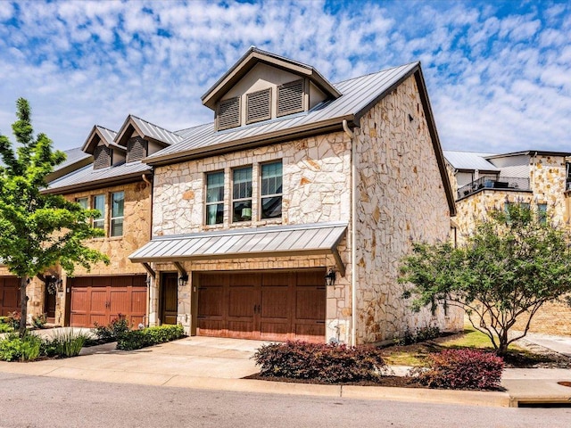 332 Adams St, Georgetown, TX 78628 - view of front of home featuring a standing seam roof, stone siding, and metal roof