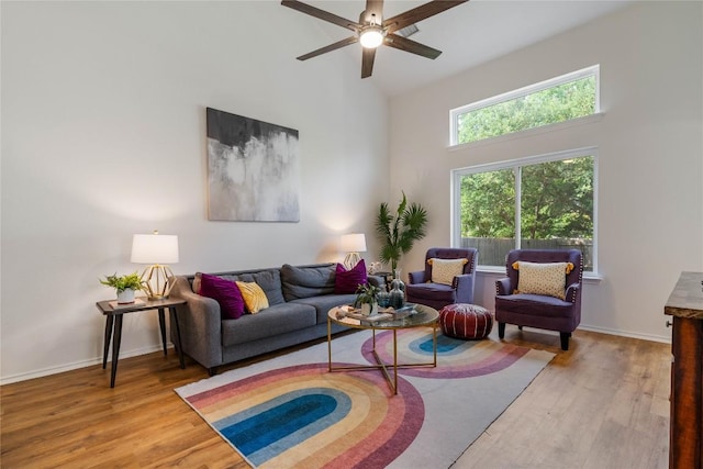11710 Raymond C Ewry Ln, Austin, TX 78748 - living room with a towering ceiling, wood finished floors, a ceiling fan, and baseboards