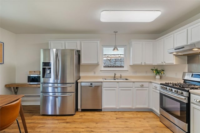 11710 Raymond C Ewry Ln, Austin, TX 78748 - kitchen featuring stainless steel appliances, under cabinet range hood, a sink, and white cabinets