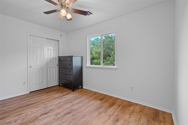 11710 Raymond C Ewry Ln, Austin, TX 78748 - unfurnished bedroom featuring baseboards, light wood-style floors, a closet, and a ceiling fan