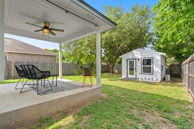 11710 Raymond C Ewry Ln, Austin, TX 78748 - view of yard featuring ceiling fan, cooling unit, an outdoor structure, and a patio