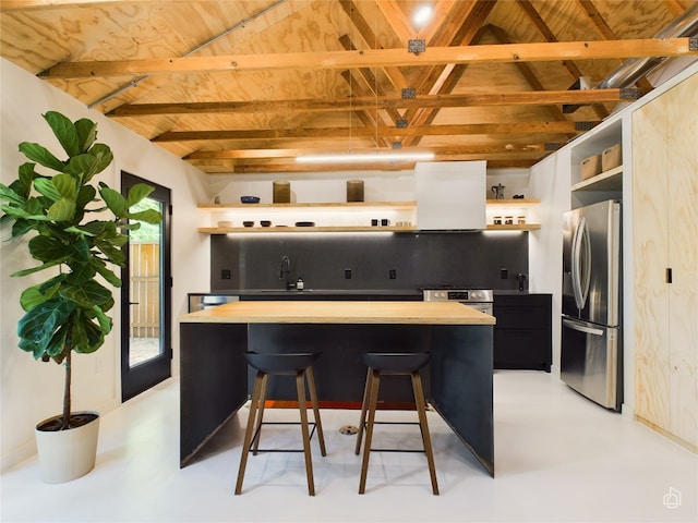 6007 Leisure Run Rd, Austin, TX 78745 - kitchen with open shelves, stainless steel appliances, exhaust hood, butcher block counters, and a kitchen breakfast bar