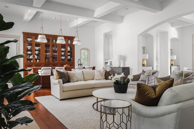 3020 Maravillas Loop, Austin, TX 78735 - living area featuring arched walkways, dark wood finished floors, beam ceiling, and recessed lighting