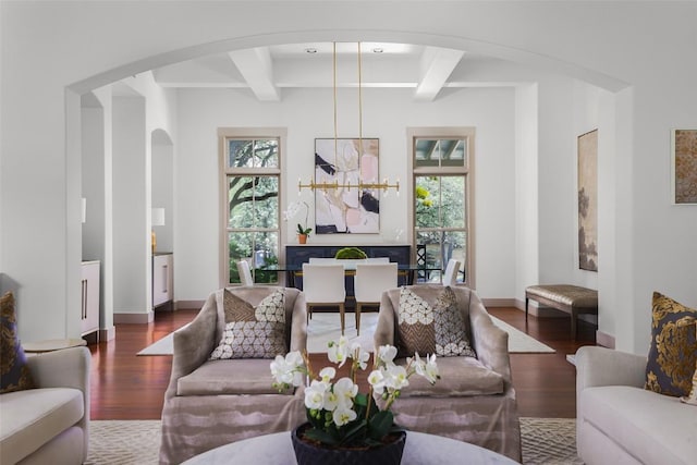 3020 Maravillas Loop, Austin, TX 78735 - living room featuring arched walkways, healthy amount of natural light, wood finished floors, and beamed ceiling
