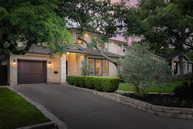 2400 Pruett St, Austin, TX 78703 - obstructed view of property featuring stone siding, a garage, and driveway