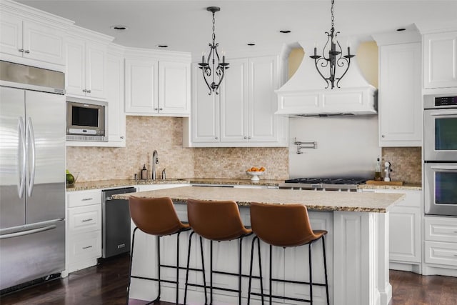 2400 Pruett St, Austin, TX 78703 - kitchen with built in appliances, a sink, a kitchen island, white cabinets, and recessed lighting