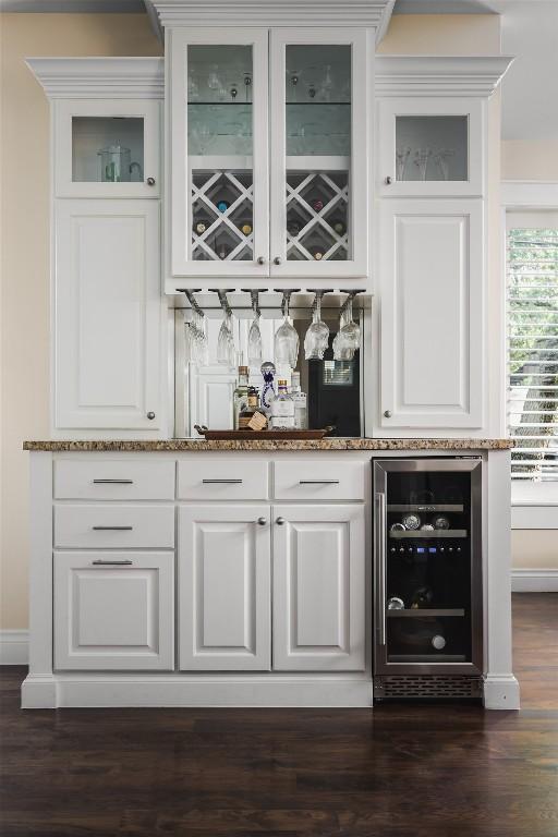 2400 Pruett St, Austin, TX 78703 - indoor bar featuring beverage cooler, baseboards, and dark wood finished floors