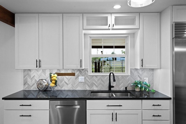204 Bridges Ln, Buda, TX 78610 - kitchen with a sink, stainless steel appliances, white cabinets, decorative backsplash, and glass insert cabinets
