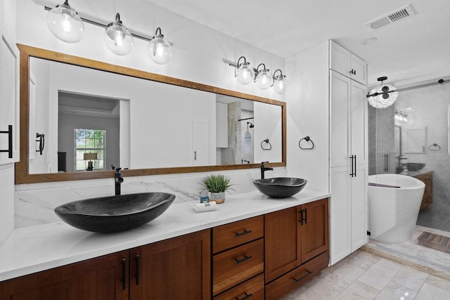 204 Bridges Ln, Buda, TX 78610 - full bath featuring a stall shower, a soaking tub, double vanity, and marble finish floors