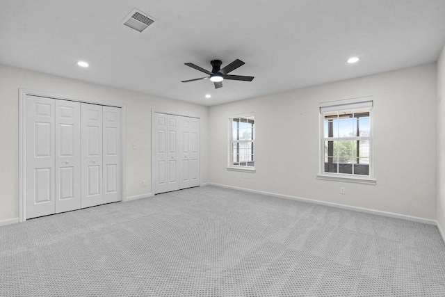 204 Bridges Ln, Buda, TX 78610 - unfurnished bedroom with multiple closets, carpet floors, baseboards, and recessed lighting