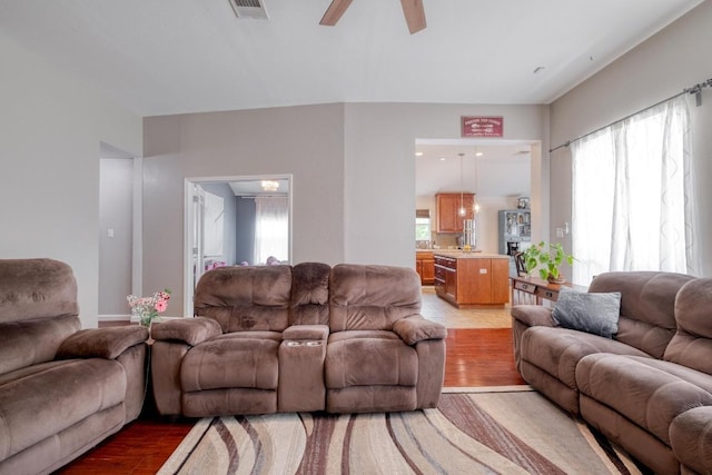 18725 Dry Lake Ln, Pflugerville, TX 78660 - living area featuring light wood-style floors, healthy amount of natural light, and ceiling fan