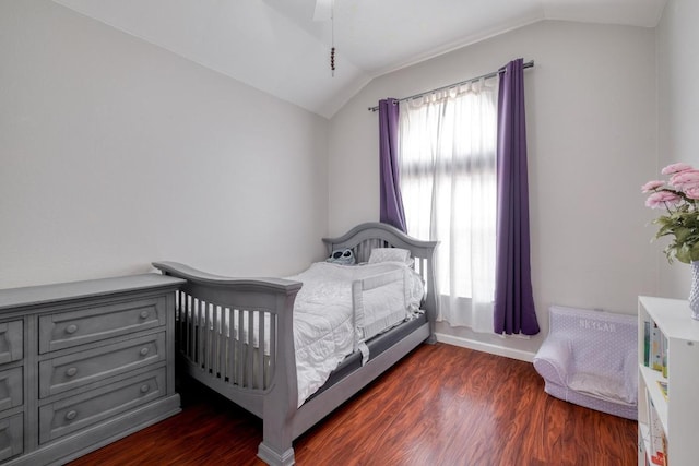 18725 Dry Lake Ln, Pflugerville, TX 78660 - bedroom with vaulted ceiling, dark wood-style flooring, and baseboards