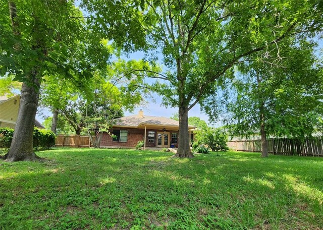 1726 Riverchase Ave, Smithville, TX 78957 - fenced backyard with french doors