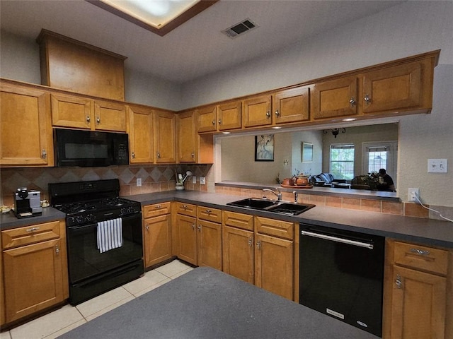 1726 Riverchase Ave, Smithville, TX 78957 - kitchen featuring black appliances, a sink, and dark countertops