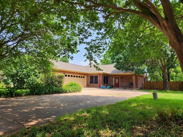 1726 Riverchase Ave, Smithville, TX 78957 - ranch-style home featuring a garage, driveway, and brick siding