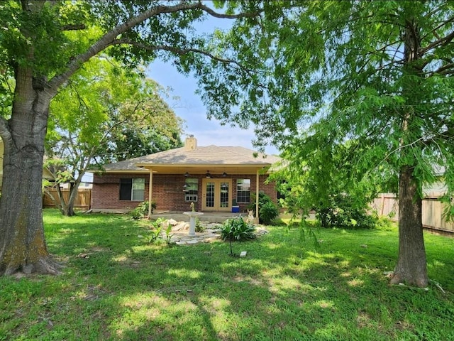 1726 Riverchase Ave, Smithville, TX 78957 - back of property with brick siding, a ceiling fan, a chimney, and a patio