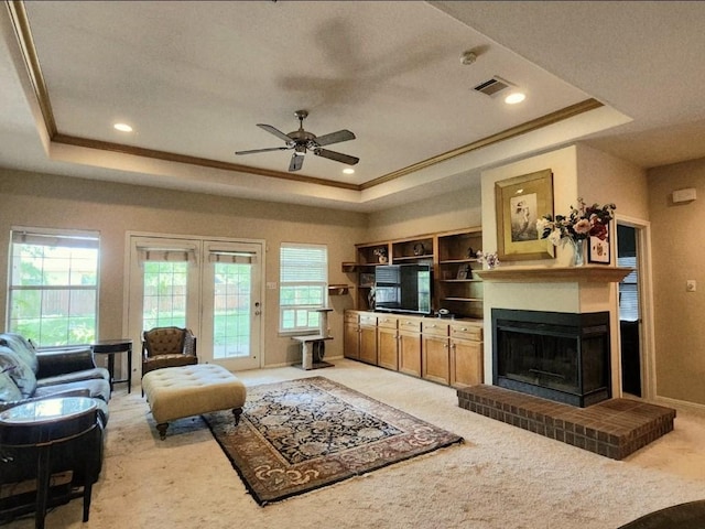 1726 Riverchase Ave, Smithville, TX 78957 - living area featuring a raised ceiling, light colored carpet, crown molding, and recessed lighting