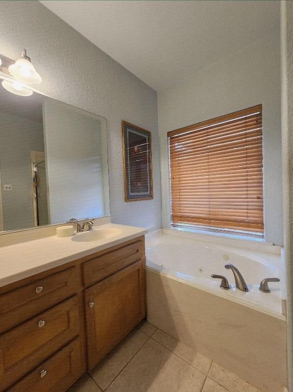 1726 Riverchase Ave, Smithville, TX 78957 - bathroom with vanity, tile patterned flooring, and a tub with jets