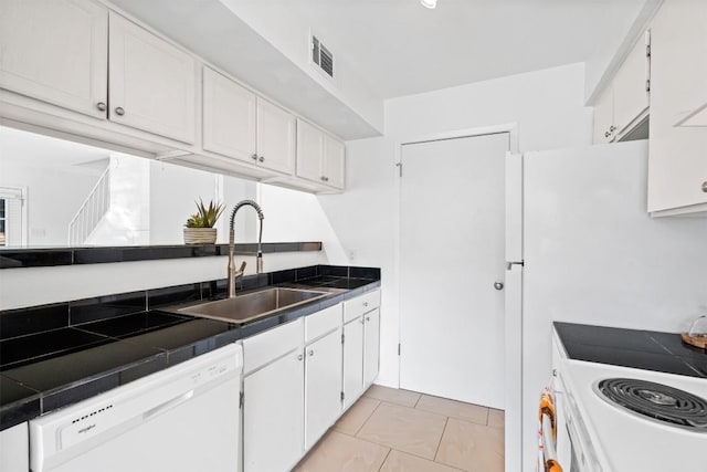 4413 Whispering Valley Dr, Austin, TX 78727 - kitchen with white appliances, a sink, white cabinetry, tile counters, and light tile patterned floors