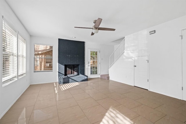 4413 Whispering Valley Dr, Austin, TX 78727 - unfurnished living room with a ceiling fan, stairway, and a brick fireplace