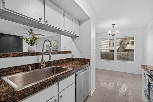 4413 Whispering Valley Dr, Austin, TX 78727 - kitchen featuring stainless steel dishwasher, a sink, white cabinets, light tile patterned floors, and a chandelier