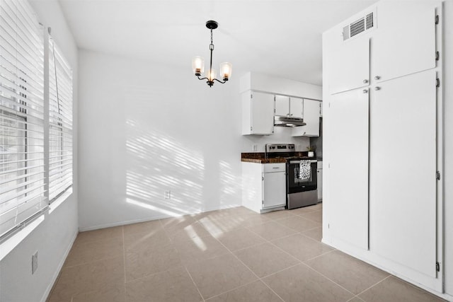 4413 Whispering Valley Dr, Austin, TX 78727 - kitchen with stainless steel stove, under cabinet range hood, a chandelier, baseboards, and light tile patterned flooring