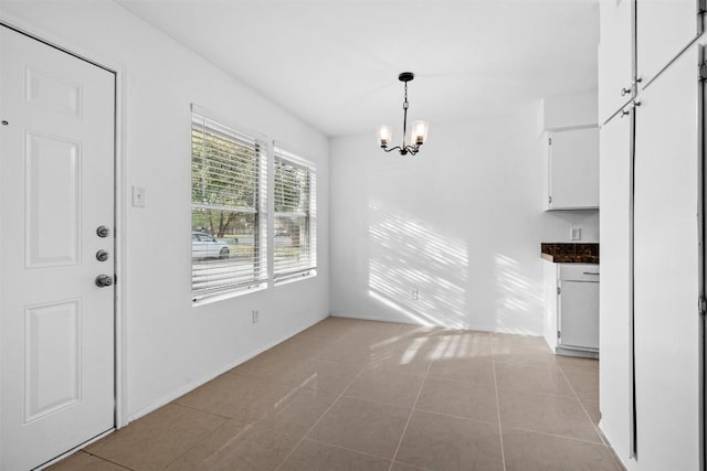 4413 Whispering Valley Dr, Austin, TX 78727 - unfurnished dining area featuring a chandelier, light tile patterned floors, and baseboards