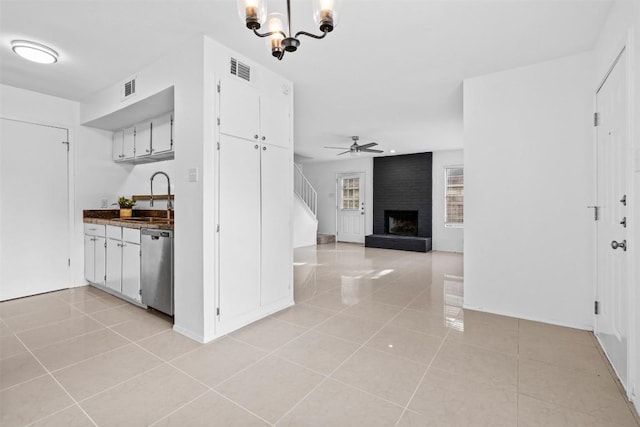4413 Whispering Valley Dr, Austin, TX 78727 - kitchen with a sink, dishwasher, light tile patterned floors, and white cabinetry