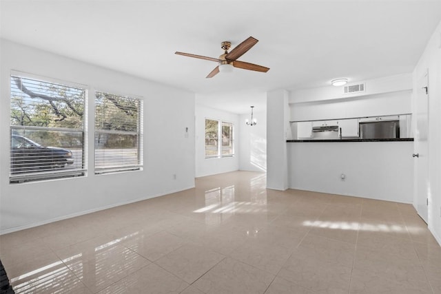 4413 Whispering Valley Dr, Austin, TX 78727 - unfurnished living room with light tile patterned flooring, a ceiling fan, and a chandelier