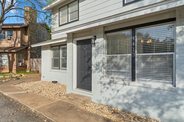 4413 Whispering Valley Dr, Austin, TX 78727 - doorway to property with brick siding