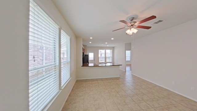 10116 Aly May Dr, Austin, TX 78748 - empty room with a ceiling fan, light tile patterned floors, recessed lighting, and baseboards