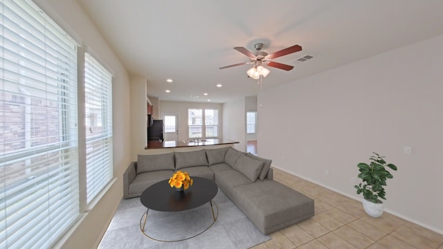 10116 Aly May Dr, Austin, TX 78748 - living room featuring light tile patterned floors, a ceiling fan, and recessed lighting