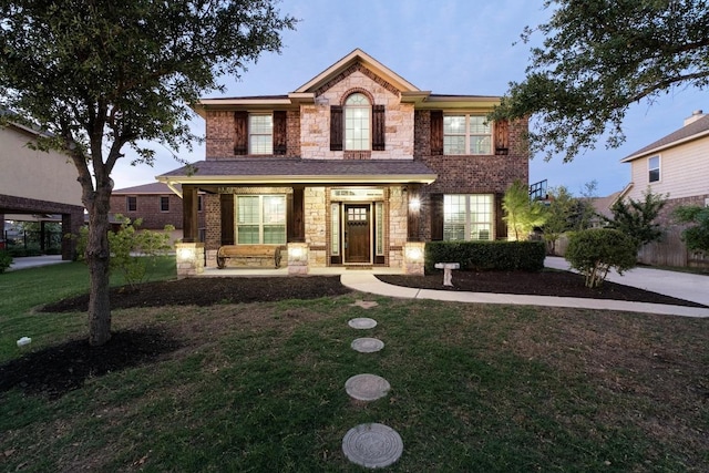 5109 Scenic Lake Dr, Georgetown, TX 78626 - view of front of property with stone siding, a front yard, covered porch, and brick siding