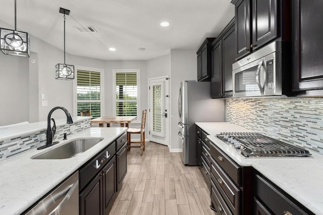 5109 Scenic Lake Dr, Georgetown, TX 78626 - kitchen featuring stainless steel appliances, a sink, backsplash, decorative light fixtures, and recessed lighting