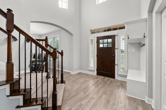 5109 Scenic Lake Dr, Georgetown, TX 78626 - entryway featuring arched walkways, stairway, wood finished floors, and a high ceiling