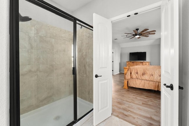 5109 Scenic Lake Dr, Georgetown, TX 78626 - ensuite bathroom featuring a shower stall, wood finished floors, a ceiling fan, and baseboards