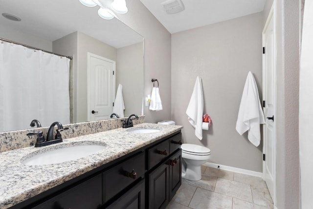 5109 Scenic Lake Dr, Georgetown, TX 78626 - full bathroom featuring double vanity, toilet, baseboards, and tile patterned flooring