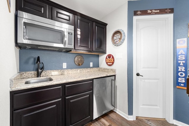 5109 Scenic Lake Dr, Georgetown, TX 78626 - kitchen featuring stainless steel microwave, a sink, dark wood-type flooring, refrigerator, and baseboards