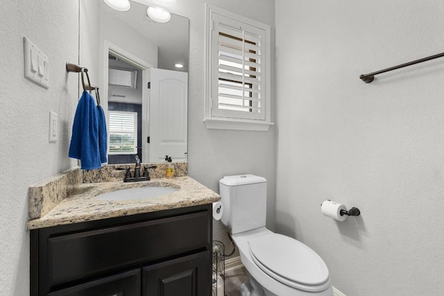 5109 Scenic Lake Dr, Georgetown, TX 78626 - half bathroom featuring vanity, toilet, and baseboards
