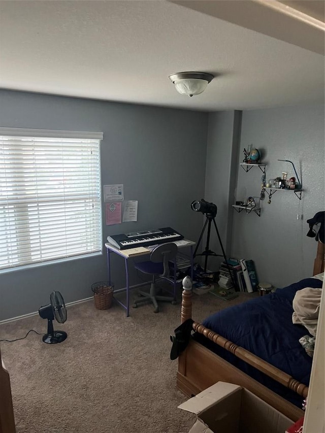 carpeted bedroom featuring baseboards