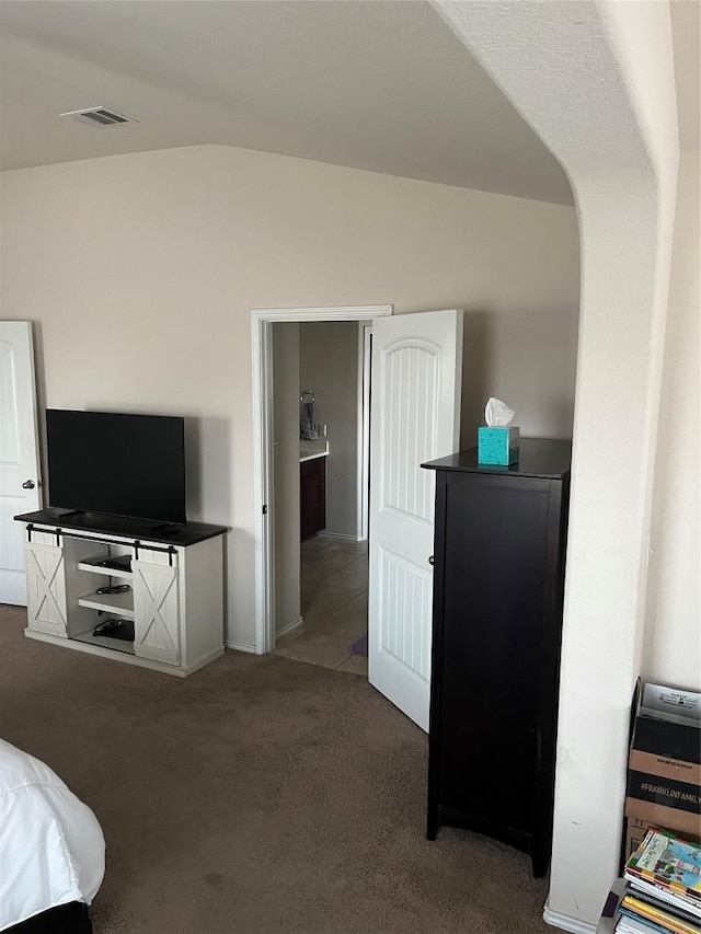 bedroom featuring carpet and lofted ceiling