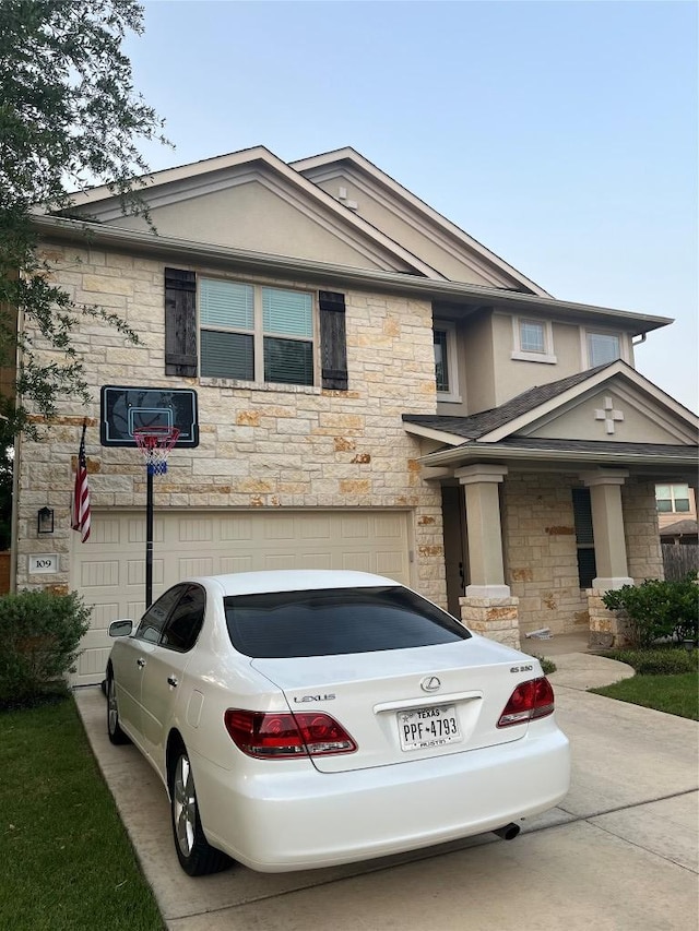 view of front of house featuring stone siding, a garage, and driveway