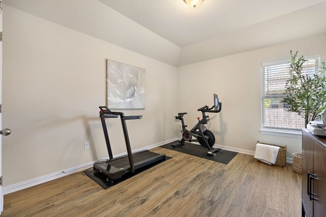 3633 Mineral Dr, Leander, TX 78641 - exercise area featuring wood finished floors, baseboards, and vaulted ceiling