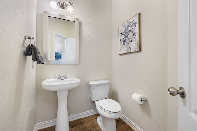 3633 Mineral Dr, Leander, TX 78641 - bathroom with toilet, wood finished floors, a sink, and baseboards