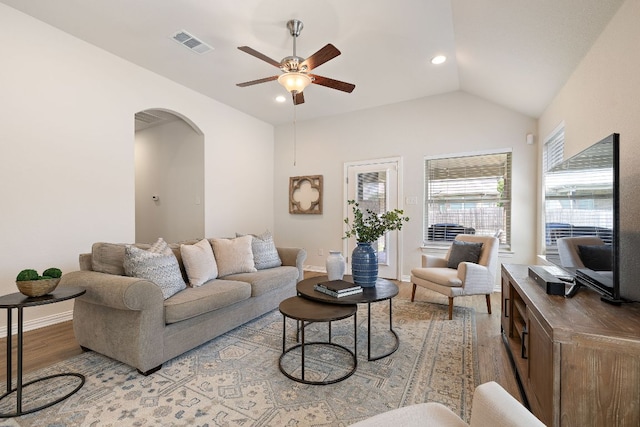 3633 Mineral Dr, Leander, TX 78641 - living area featuring light wood-type flooring, ceiling fan, arched walkways, baseboards, and lofted ceiling