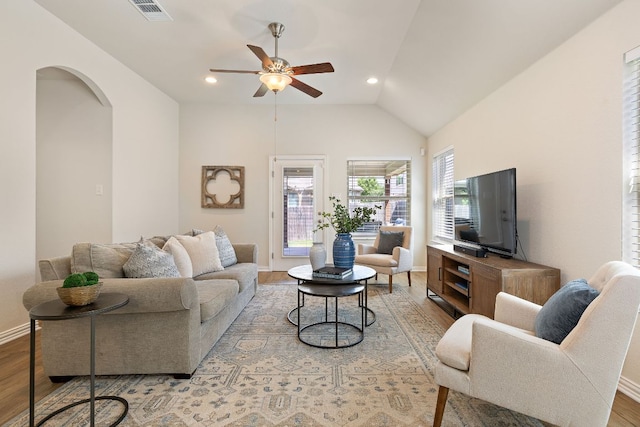 3633 Mineral Dr, Leander, TX 78641 - living area featuring wood finished floors, a ceiling fan, arched walkways, baseboards, and lofted ceiling