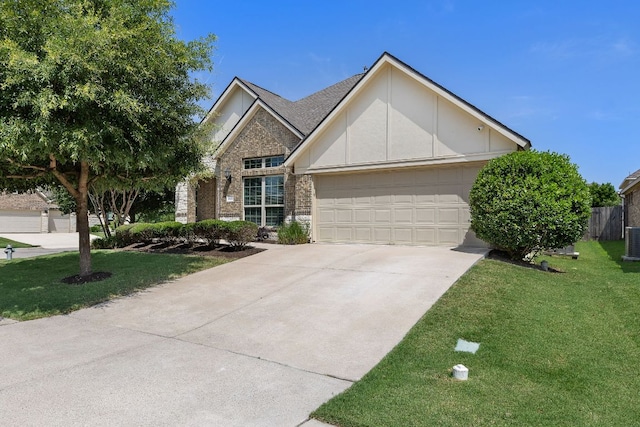 3633 Mineral Dr, Leander, TX 78641 - view of front of home featuring a garage, concrete driveway, central AC, and stone siding
